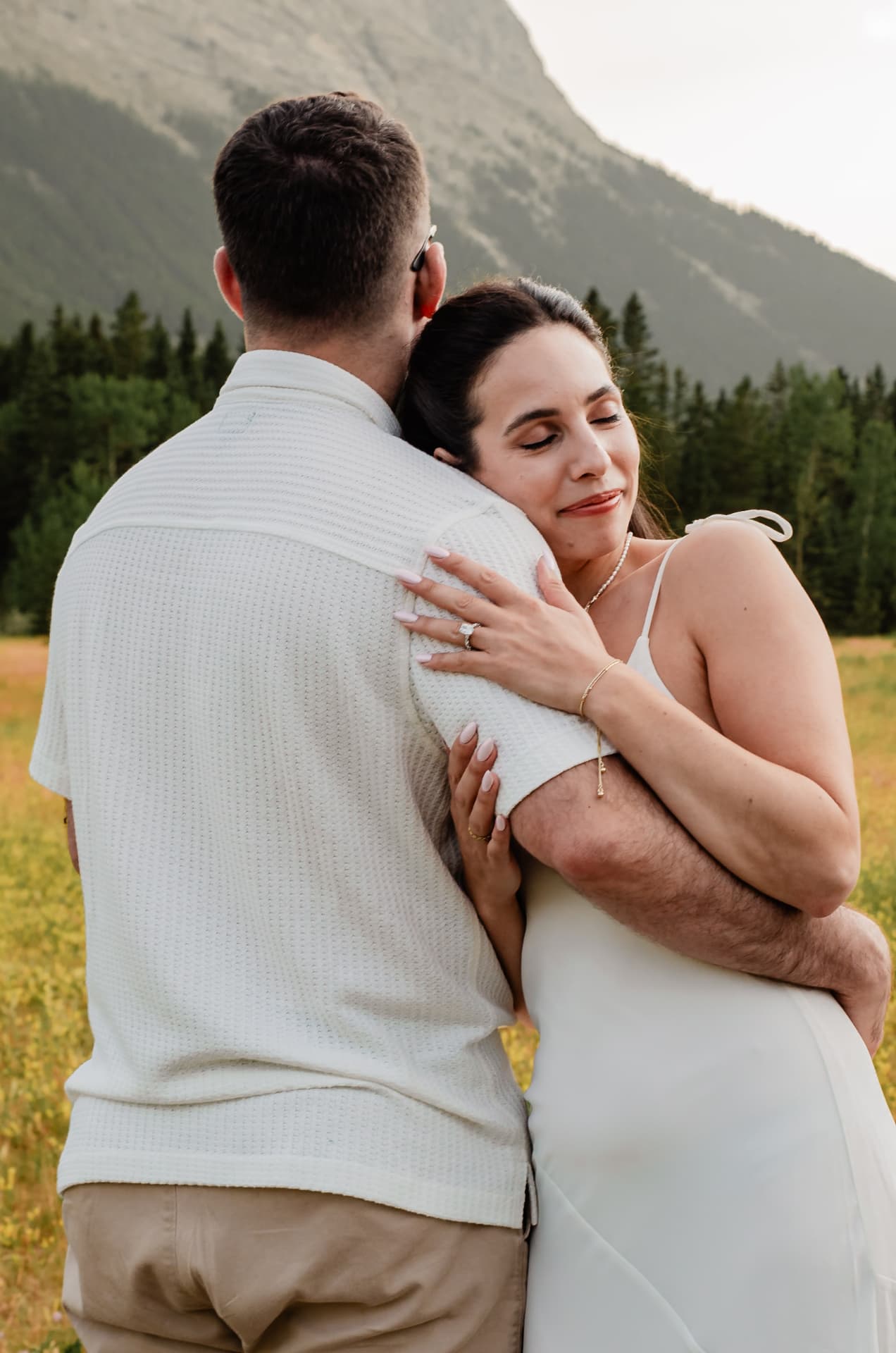 Nathalie and David embracing in a mountain meadow