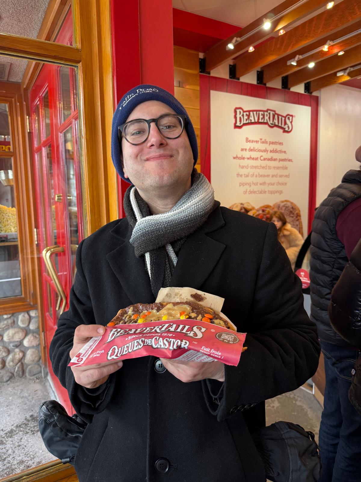 David with a BeaverTails pastry in Banff